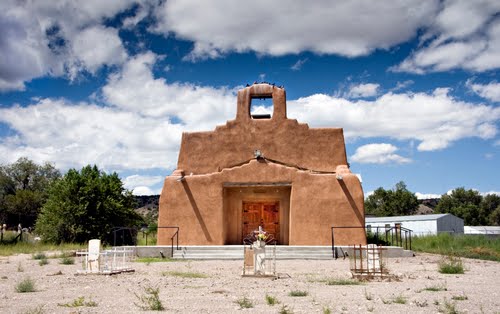 Adobe church with graveyard in the foreground.